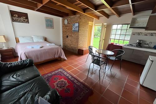 a living room with a bed and a table and chairs at Finca Moralia in Cajicá