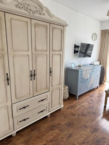 a bedroom with a large white cabinet and a desk at Отдых у моря Одесса in Kryzhanivka