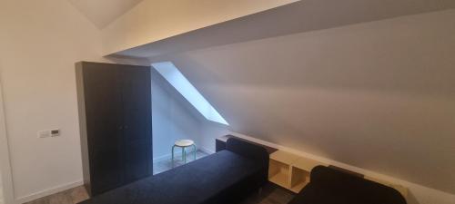 a room with a staircase with a skylight at Nomad's Place in Cireşu