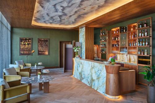 a bar in a restaurant with a marble ceiling at The St. Regis Cap Cana Resort in Punta Cana