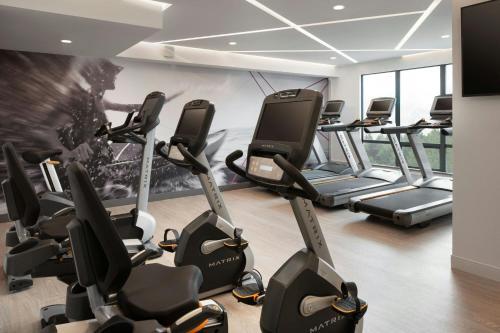 a gym with a bunch of treadmills at Vancouver Airport Marriott Hotel in Richmond