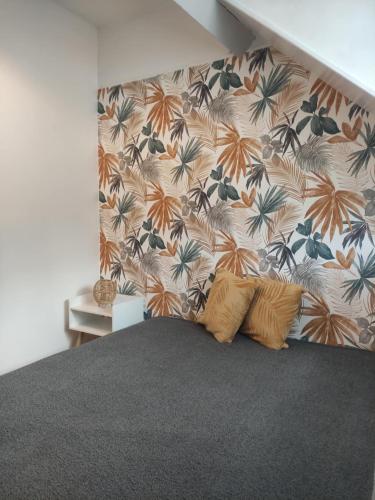 - une chambre avec un lit orné d'un mur fleuri dans l'établissement Villa Lumière, à La Bourboule