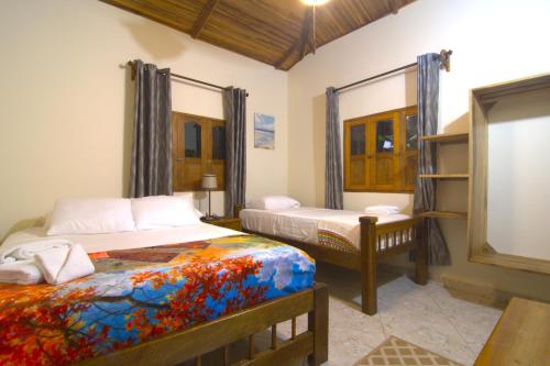 a bedroom with two beds and a window at Tayrona Farm House Sleep 15 AC Breakfast included in Buritaca