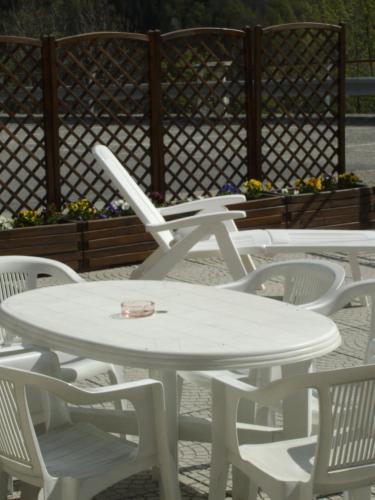 a group of white tables and white chairs at Da Cecilia in Bognanco