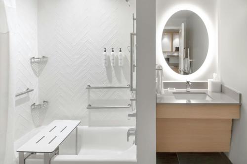 a bathroom with a sink and a mirror at TownePlace Suites by Marriott Detroit Taylor in Taylor
