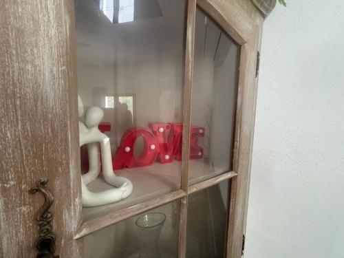 a wooden cabinet with figurines inside of it at Love zen et spa in Solliès-Toucas