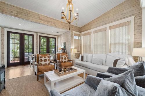 a living room with a couch and a table at 67 Wiggle Lane - Rosemary Beach - Steps to Tennis Courts, Beach, Pools! in Rosemary Beach