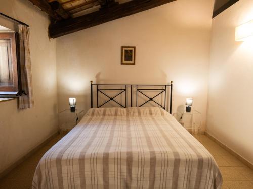 a bedroom with a large bed in a room at Agriturismo Baglio Fontana in Buseto Palizzolo