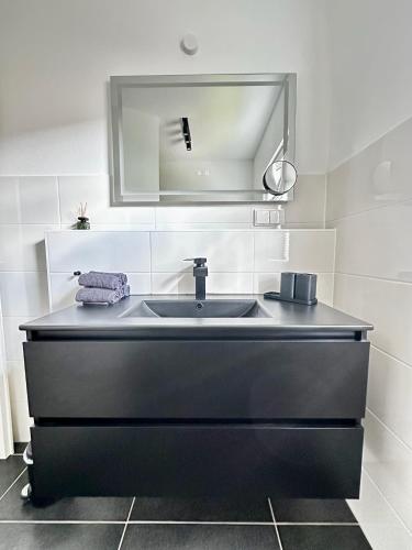 a bathroom with a sink and a mirror at Soulmates Resorts - Feldberg in Feldberg
