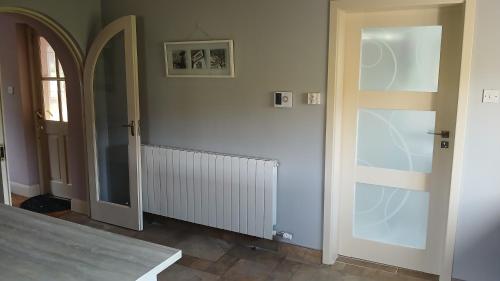 a hallway with an open door and a window at shiv's comfy apartment in Balnacart