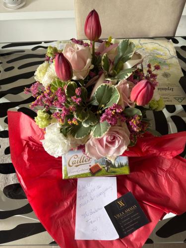 a bouquet of flowers sitting on a bed at Villa Amalia in Avellino