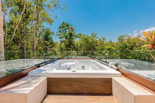 a bath tub on the roof of a house at Casa Jaguar in Xpu Ha