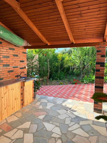 an outdoor patio with a wooden pergola at Arial Trinity Suites in Vlorë