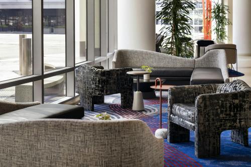 a lobby with couches and tables and windows at Courtyard by Marriott Los Angeles L.A. LIVE in Los Angeles