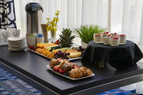 a table with two plates of food on a table at Courtyard by Marriott Los Angeles L.A. LIVE in Los Angeles
