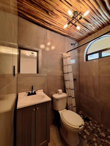 a bathroom with a toilet and a sink at Hotel VSI in Playa del Carmen