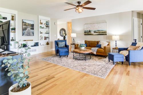 a living room with a couch and blue chairs at Newly Renovated Lake Bowen Home with Game Room! in Campobello