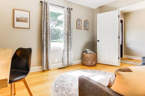 a living room with a couch and a table and a window at Newly Renovated Lake Bowen Home with Game Room! in Campobello