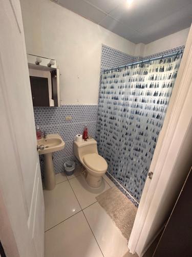a bathroom with a toilet and a sink and a shower at Country House in Los Planes VACATION RENTAL in Panchimalco