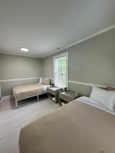 a bedroom with a large bed and a window at Family Home Pool HotTub Near Lighthouse Point Park in New Haven