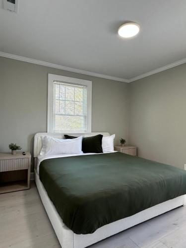 a bedroom with a large bed and a window at Family Home Pool HotTub Near Lighthouse Point Park in New Haven
