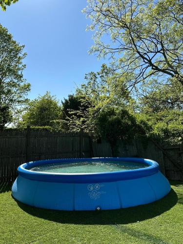 a large blue bird bath in a yard at Family Home Pool HotTub Near Lighthouse Point Park in New Haven