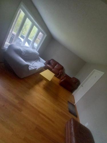 an attic room with a bed and a window at Homestay at Heart Of Kitchener-Free Wifi & Parking in Kitchener