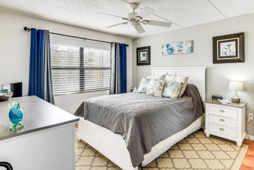 a bedroom with a bed and a window at Walk to Ocean Daytona Beach Shores Condo with Pool! in Daytona Beach Shores
