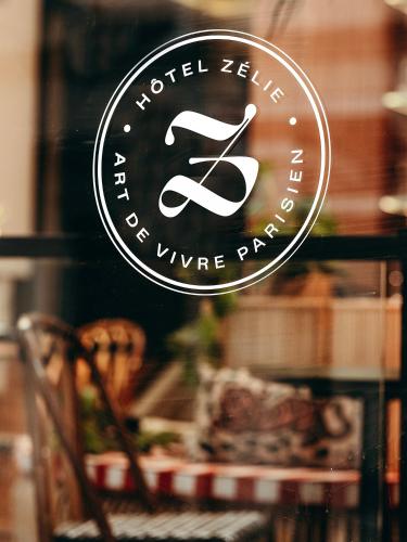a sign on a window of a wine shop at Hôtel Zélie in Paris