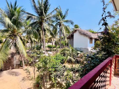 a view of a house and palm trees at Casa Hugo 2 AC Starlink 2min walk to the beach in Brisas de Zicatela