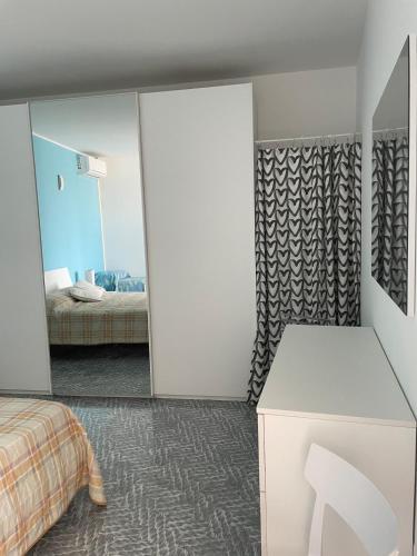 a bedroom with a bed and a mirror at Oasi nel Salento in Tricase