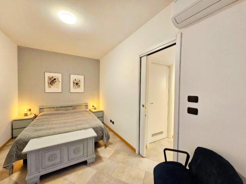 a bedroom with a bed and a table in it at Nido del Golf in Albisola Superiore
