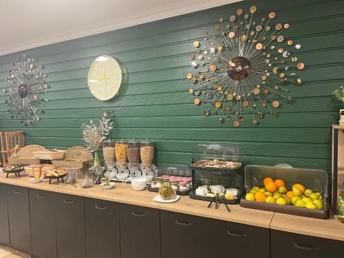 a buffet with fruits and food on a table at Hotel Le Gambetta in Bergerac