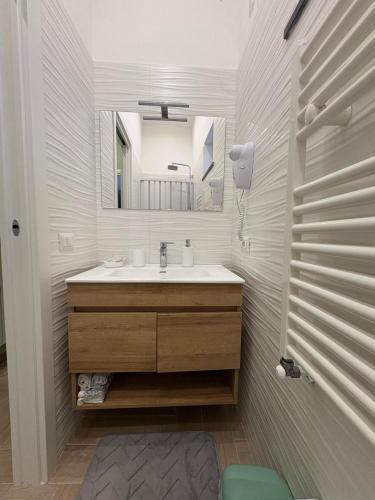 a bathroom with a sink and a mirror at Don Mimì Casa Vacanza in Torre del Greco