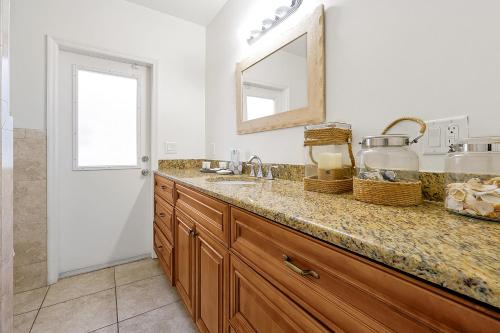a bathroom with a sink and a mirror at Villa with Beach Front Views in Cocoa Beach