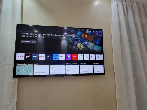 a flat screen tv hanging on a wall at Villa Marrakech Rimass - 6 Chambres Dont 5 Suites Luxe, Piscine Privee & Jardins in Marrakech