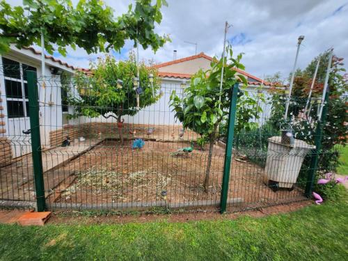 a bird cage in the yard of a house at Casa Azul donde se respira tranquilidad in Lardero