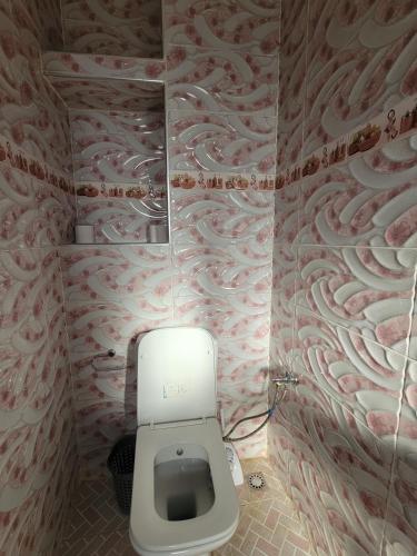 a bathroom with a white toilet in a room at Villa Marrakech Rimass - 6 Chambres Dont 5 Suites Luxe, Piscine Privee & Jardins in Marrakech