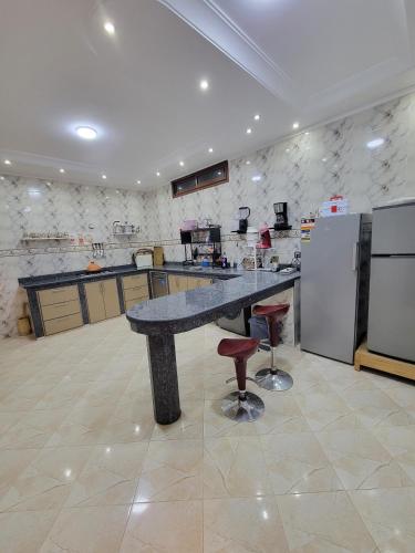 a large kitchen with a large granite counter top at Villa Marrakech Rimass - 6 Chambres Dont 5 Suites Luxe, Piscine Privee & Jardins in Marrakech