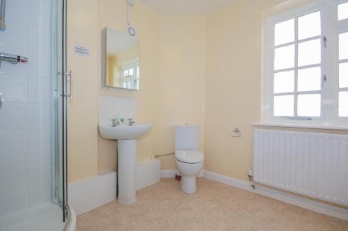 a bathroom with a toilet and a sink and a shower at Harris Guest Accommodation in Oxford