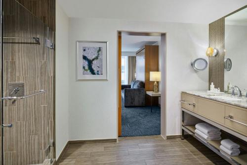 a bathroom with a shower and a sink and a mirror at JW Marriott Austin in Austin
