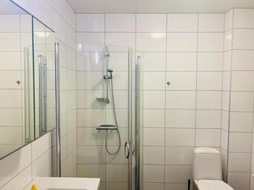 a bathroom with a shower and a toilet at Cozy room with two single bed in near by Eslöv station in Eslöv
