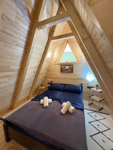 a bedroom with a bed with two towels on it at Dream House Una in Orašac