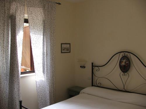 a bedroom with a bed and a window at Agriturismo Fara del Falco in Vieste