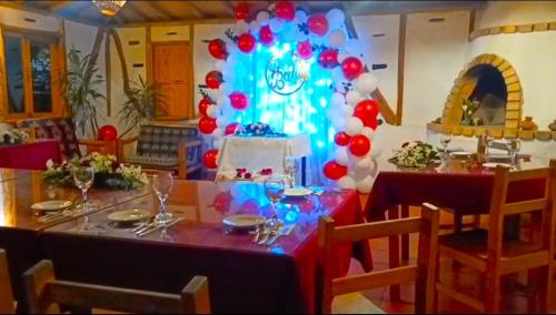 a dining room with a table with red and blue balloons at Hotel La Casa de Francois in San Agustín
