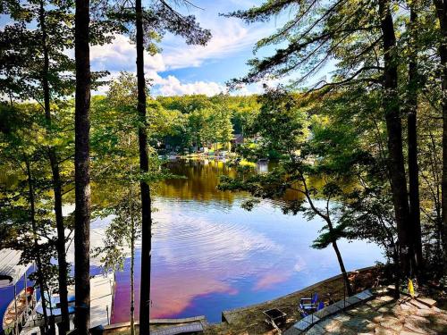 a view of a lake in the middle of a forest at Lakefront Home-Stunning Views-Hot Tub, 3100 sqft! in Wakefield