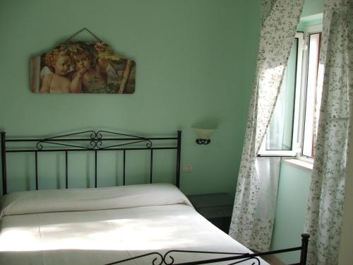 a bedroom with a bed with a picture on the wall at Agriturismo Fara del Falco in Vieste