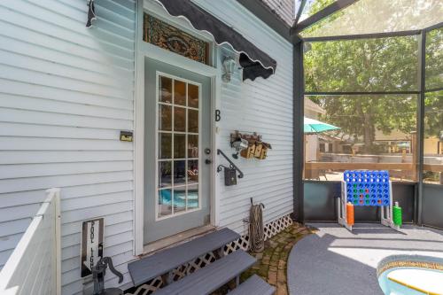 a front door of a house with a blue chair at Martin B- historic district apt with pool in Ocala