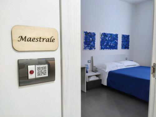 a room with a bed and a door with a clock at 41 Parallelo - Comfort rooms in Bari
