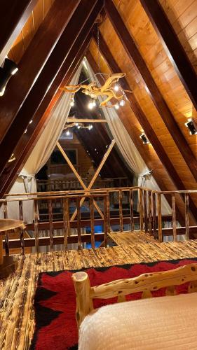 a bedroom with a large bed in a attic at Bujtina Fati Art in Ersekë